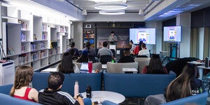 People gathered in chairs around an open mic presenter at ASU Library's Labriola National American Indian Data Center.