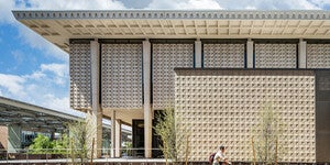 Cyclist riding by Hayden Library on ASU Tempe campus