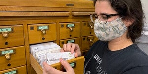 ASU library specialist Christina Sullivan next to the card catalog