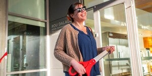 Portrait of Kaitlin Reed holding oversized prop scissors 