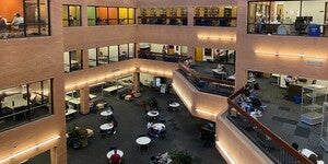 An interior view of Noble Library with people sitting, reading and studying on the first, second, third floor