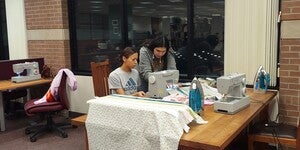 Baylee LaCompte helping an ASU student with her ribbon skirt at West campus Labriola