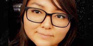 Headshot of Janine Nelson wearing black rimmed glasses.