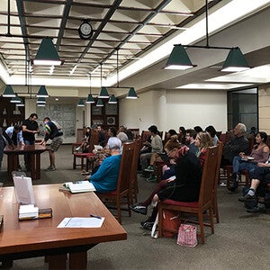 ASU students and staff sitting and watching artists prepare for talk.