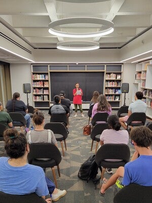 Yitaba Largo-Anderson (Diné) reading her poetry at Labriola's Open Mic.