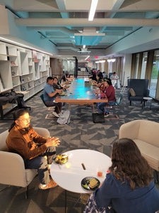 Indigenous graduate and doctoral students having dinner at a table.