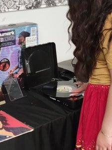 Photo of student's hands interacting with turntable