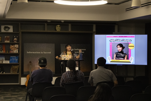 Ayling Dominguez reading her poems in front of audience