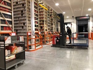 A person driving a forklift in a warehouse