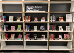 Shelves and book display featuring materials related to "Hyphen" by Pardia Mahdavi