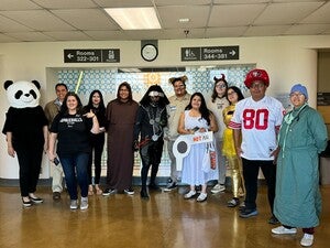 Pictured (left to right): Dr. Laura, Eric Hardy (Diné), Alycia De Mesa (Apache of Chihuahua, Mexico, mestiza, Japa) as Spaceballs merchandise, Arianna Halona (Diné) as Morticia, Eli Shepherd (Diné) as a Dink, Alex Soto (Tohono O'odham) as Dark Helmet, Nataani Hanley-Moraga (Diné and Lakota) as “good” Barf, Vina Begay (Diné) as Princess Vespa, “Evil” Barf, Mafi Pamaka (Tongan) as Dot Matrix, Jim Larney (Seminole) as sports fan, and Elena Dominguez (Mexican American and Pascua Yaqui descent) as Dr Schlotkin. 