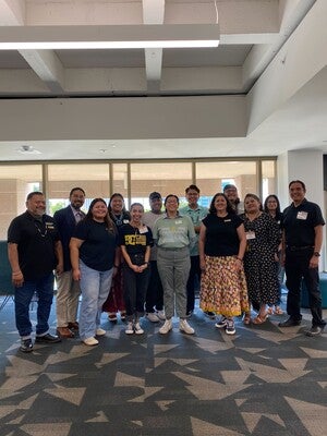 Featured in picture (from left to right): Penrose Fulwilder, (Tohono O'odham), Director Alex Soto (Tohono O'odham), Monica Harvey (Dine'), Ashley Davis (Diné), Yitazba Largo-Anderson (Dine'), Tait Wilson (Afro-Indigenous Tohono O'odham), Elena Dominguez (Pascua Yaqui), Alycia de Mesa (mixed race American of Apache and Indigenous of Chihuahua, Coahuila, and Durango, Mexico, Japanese, and British-German ), Nataani Hanley-Moraga (Diné and Lakota), Vina Begay (Diné), Arianna Halona (Diné), Eric Hardy (Diné).