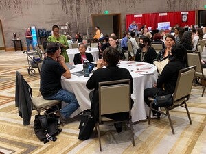 Pictured is Eric Hardy (Diné) and Yitazba Largo-Anderson (Diné) speaking to ATALM participants at a round table presentation