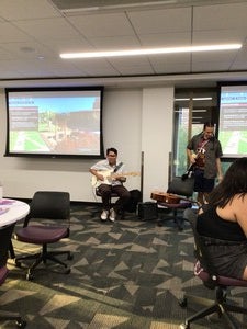 Pictured is Eli Shepherd (Diné) playing on his guitar in room 236 with Indigenous students