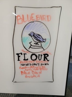 Drawing of Blue Bird Flour sack on white board 