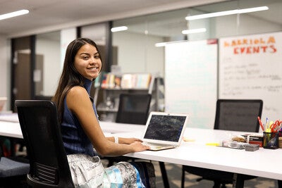 Student sitting at table looking at the camera