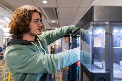 Person working on a 3D printer 