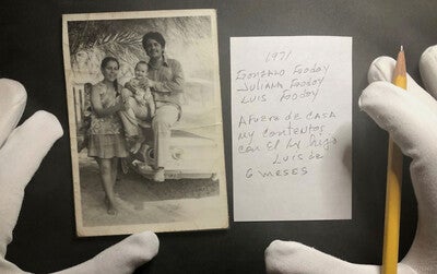 archivist hands in gloves applying proper documentation to a photo